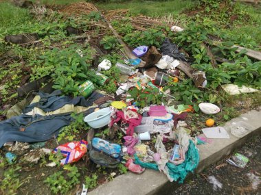 Perak,Malaysia. January 25,2023:Illegal and irresponsible dumping of domestic waste materials along the bushy roadside at Taman Mas 1,Kg Koh.