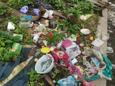 Perak,Malaysia. January 25,2023:Illegal and irresponsible dumping of domestic waste materials along the bushy roadside at Taman Mas 1,Kg Koh.