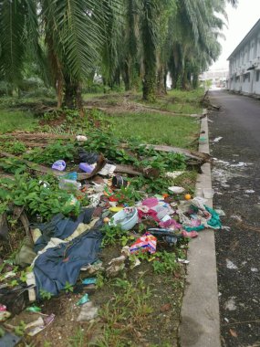 Perak,Malaysia. January 25,2023:Illegal and irresponsible dumping of domestic waste materials along the bushy roadside at Taman Mas 1,Kg Koh.
