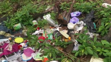 Perak,Malaysia. January 25,2023:Illegal and irresponsible dumping of domestic waste materials along the bushy roadside at Taman Mas 1,Kg Koh.