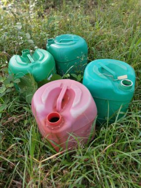 colorful pesticide containers left at the oil palm plantation. 