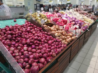 Perak, Malaysia. February 22, 2023 : Varieties of onions and garlic on the shelves for sale and display at Aeon Sri Manjung Supermarket. 