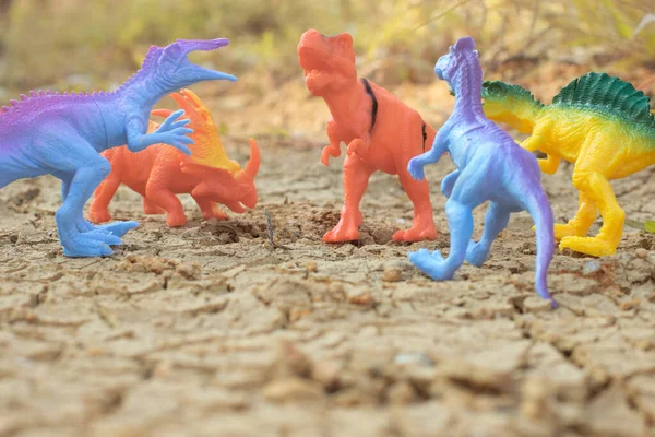 stock image infrared image of the dinosaur toys illustrating loitering around the dried land.