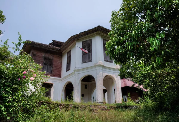 outdoor scene of the deserted and dilapidated colonial building.