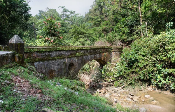 stock image landscape scene of the old weathered bridge along the asphalt road