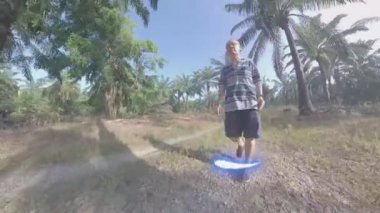 Yağ palmiyesi tarlasında yürüyen adam modeli.  