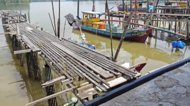 Perak, Malezya. 21 Haziran 2023: Kuala Sepetang, Taiping 'deki kıyı mangrov bölgesi boyunca yer alan balıkçı köyü çevresindeki evler ve faaliyetler.