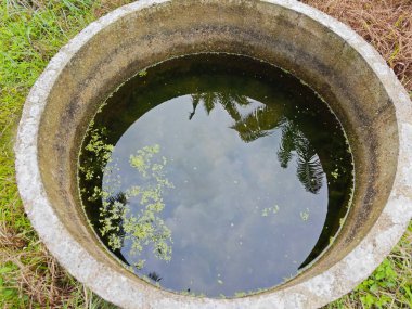 Silindirik beton kuyunun yüzeyine bakıyorum..