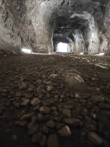 scene around the tunnel passage in the dark cave.