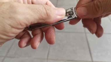 Birisi tırnak makası ile tırnağını kesmiş..
