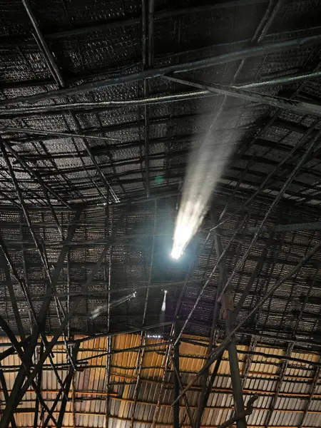 hole on the roof ceiling leaking a beam of light.