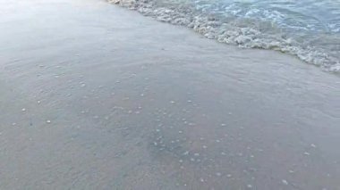 Su sıçrıyor kumlu sahile çarpıyor..