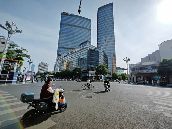 stock image Yunnan, China. April 26, 2024: Environment city scene of people walking along the business street at Kunming urban city.