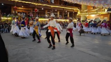 Yunnan, Çin. 23 Nisan 2024: Lugu Gölü yerleşim köyü LiJiang 'daki Mosuo kültür kabilesinin gece ateşi dans sahnesi.