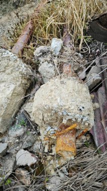 Çökmüş ya da paslı metal direği sökmüş. Çiftlikteki zemine beton temel atmış..