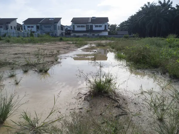 stock image aerial scene of the residential vicinity with an outdoor huge puddle. 