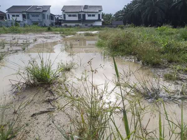 stock image aerial scene of the residential vicinity with an outdoor huge puddle. 