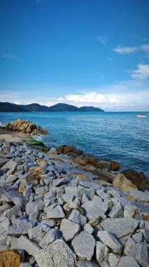 Beyaz kumlu sahil çevresindeki deniz manzarası.