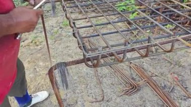 İnşaat için metal telleri blok biçimindeki paslı çelik şebekeye bağlayan birinin video klipsi..  