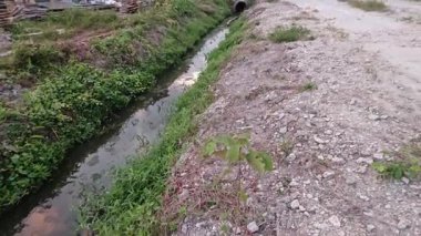 Şafak vakti güzel gökyüzü inşaat alanındaki dar kanalizasyon yolu boyunca. 