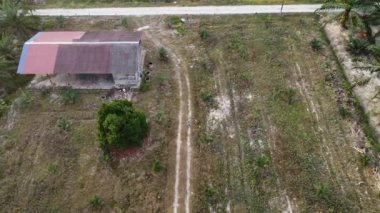 Hala yapım aşamasında olan boş arazinin etrafında insansız hava aracı uçuran bir adamın hava görüntüleri..  