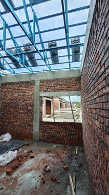 Tavan inşaatının tepesinde çatı kirişleri olan hafif alüminyum çelik kirişe bakıyorum..