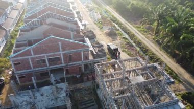 Perak,Malaysia. September 30, 2025: Footage of laborers working indoor and outdoor building up the new residential housing scheme at the Taman Indah Permai construction site. 