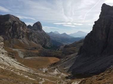 Beautiful sunny day in Dolomites, blue sky, white clouds, high mountains. Trek to the summit Sass da Ciampac (2667 m).