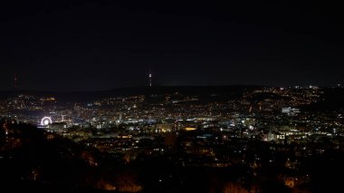 Stuttgart inner city, downtown with ferry wheel by night in winter during Christmas Market Weihnachtsmarkt