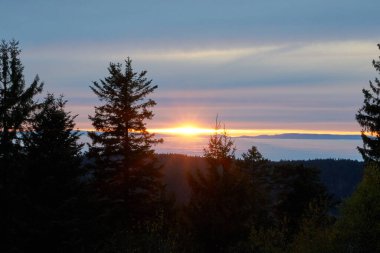 beautiful sunset over the foggy inversion rhine river valley, seen from a hill in the black forest