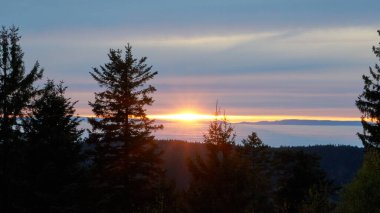 beautiful sunset over the foggy inversion rhine river valley, seen from a hill in the black forest