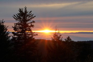beautiful sunset over the foggy inversion rhine river valley, seen from a hill in the black forest