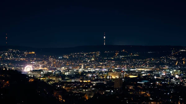 Stuttgart inner city, downtown with ferry wheel by night in winter during Christmas Market Weihnachtsmarkt
