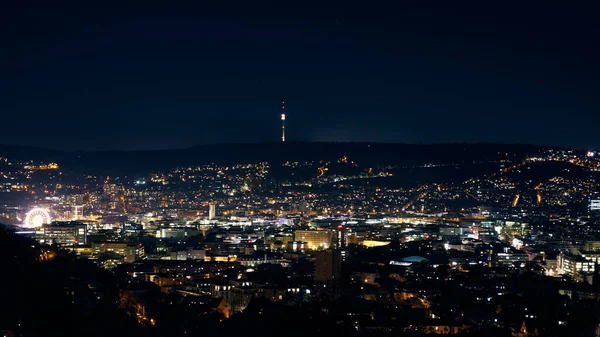 Stuttgart inner city, downtown with ferry wheel by night in winter during Christmas Market Weihnachtsmarkt