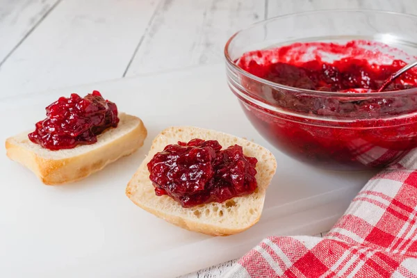 Classic cinnamon orange cranberry sauce close-up. Bread with fresh cooked cranberry sauce.