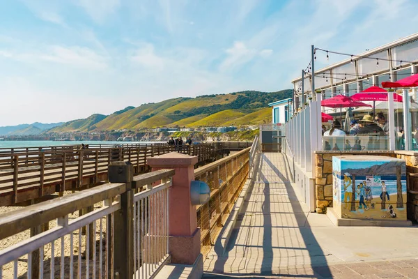 stock image Pismo Beach, California, USA - April 6, 2023. Pismo Beach pier plaza, shops and restaurants, and a wooden boardwalk along the shore