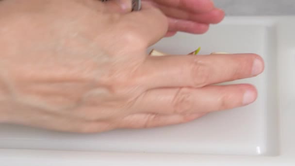 Woman Presses Fresh Garlic Using Garlic Press Tool White Cutting — Stock Video