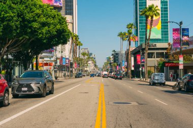 Los Angeles, California, USA - April 26, 2023.   Sunset Boulevard in West Hollywood on a bright sunny day. Architecture, traffic, city life clipart
