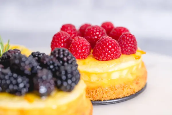 Classic mini cheesecakes with berry toppings close-up. Homemade cheesecake recipe