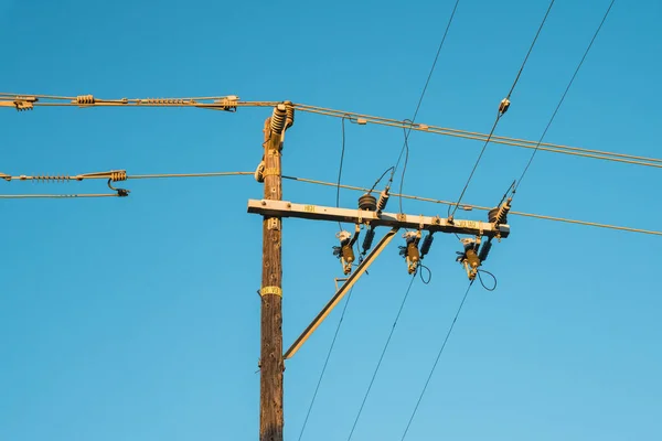 Power electric pole line with blue sky in the background