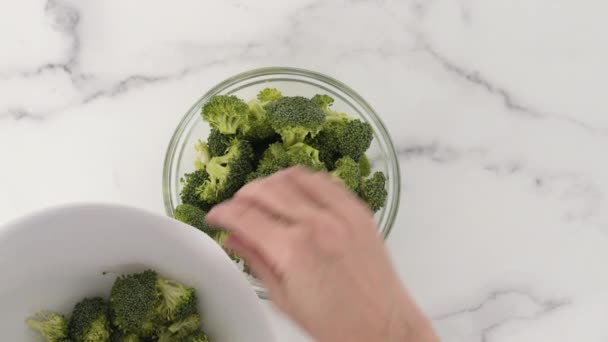 Raw Organic Broccoli Florets Glass Bowl Close Marble Background Flat — Stock Video