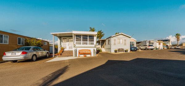 Pismo Beach, California, USA - November 29, 2023. Mobile home park. A row of residential mobile park homes in Pismo Beach, street view. Lifestyle, architecture