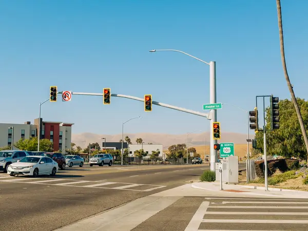 Stock image Santa Maria, California, USA - July 20, 2024. Intersection with traffic lights and California 101 North South sign under a clear blue sky.