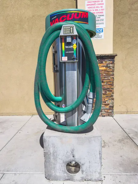 stock image Santa Maria, California, USA - July 21, 2024. Car wash vacuum machine with green hoses and instructional sign.