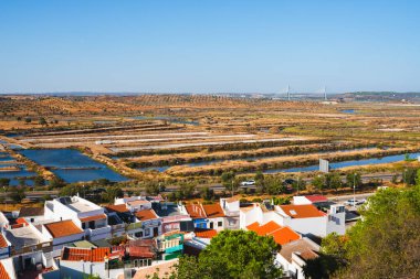 Aerial view of Castro Marim, Portugal, with traditional houses and salt pans in the background. clipart