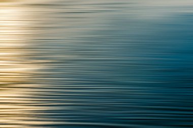 Soft gradient of warm light and cool water creates a peaceful effect.