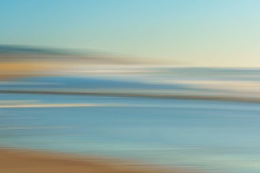 Sunset on the beach, abstract. Motion blur abstract seascape in light turquoise and yellow colors, copy space
