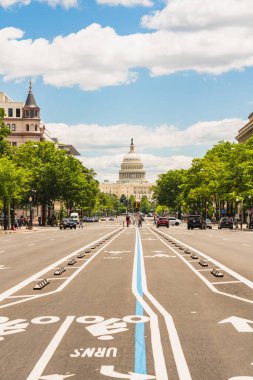 Washington D. C., USA - May 24, 2025. A clear view of the United States Capitol building from a central lane of Pennsylvania Avenue.