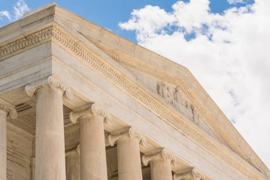 Washington D. C., USA - May 24, 2025. A close-up view of the Jefferson Memorial shows its intricate pediment sculpture and marble columns.