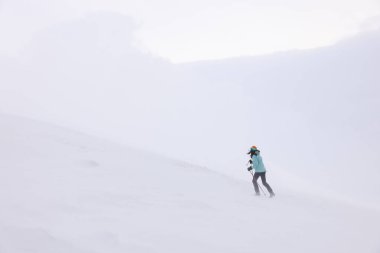 Winter mountain climbing in harsh blizzard conditions, Parng Mountains, Romania, Europe